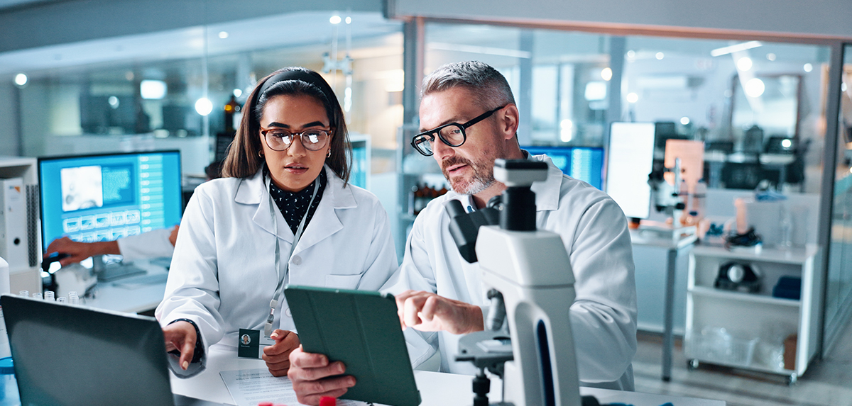 Medical researchers examining information on screen