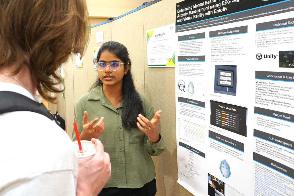 Student presenting poster in open room at Union.